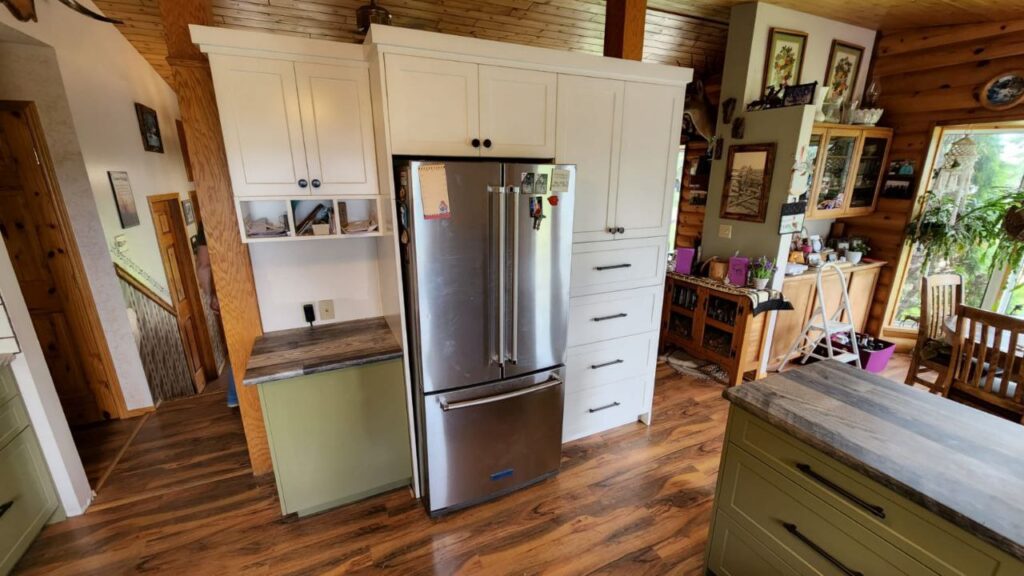 White and mint cabinets with a wooden countertop