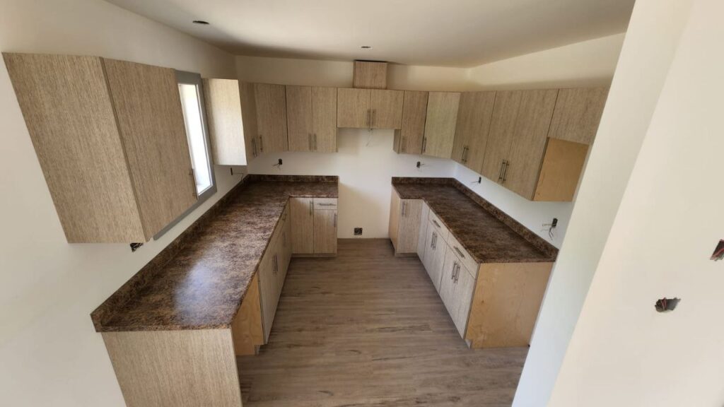 Neutral cabinets with a brown countertop design in a kitchen.
