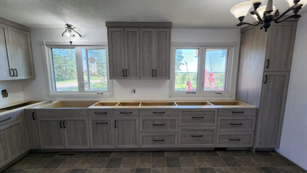 Kitchen cabinets with a mix of marble grey finishes installation.