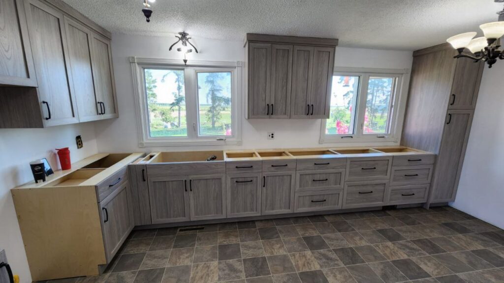 Cabinets with a mix of marble grey finishes in a kitchen.