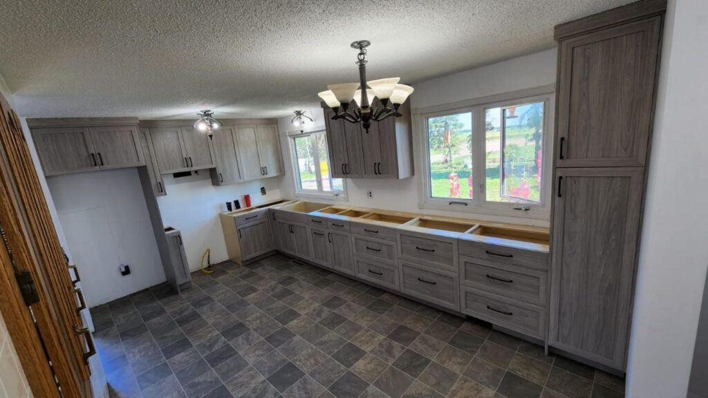 Light oak cabinets in a bright and airy kitchen.