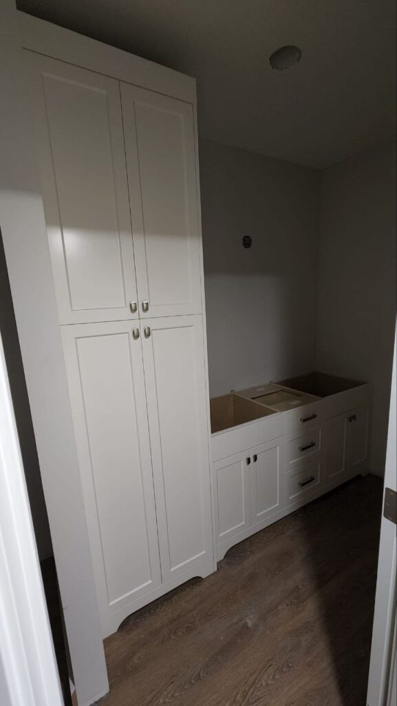 White storage cabinets in a walk in closet