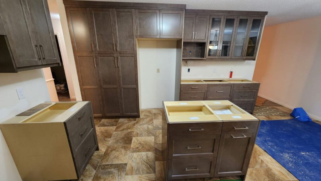 Wooden cabinets with glass shelving in the kitchen.