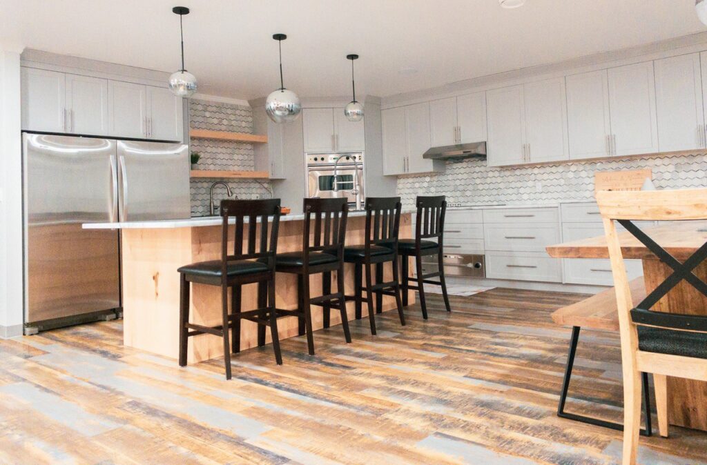 Open kitchen with white cabinets, and an island with white countertops