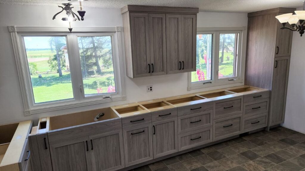 Dark grey cabinets in a kitchen with windows