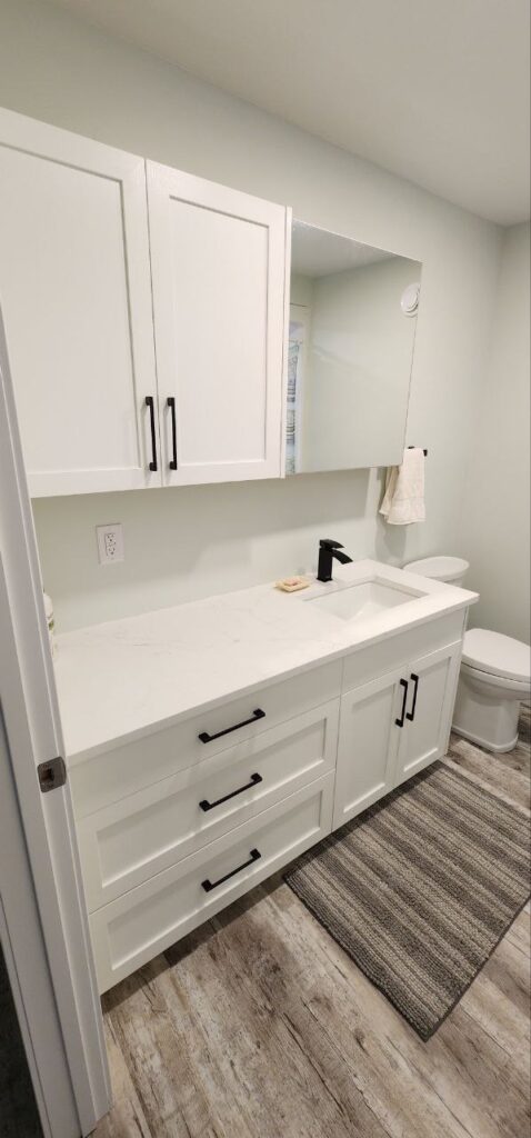 White storage cabinets with mirror in a toilet