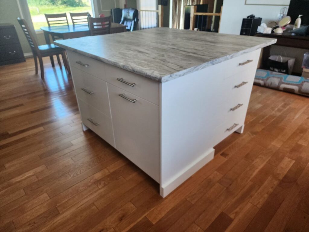 White cabinet storage with a grey marble countertop