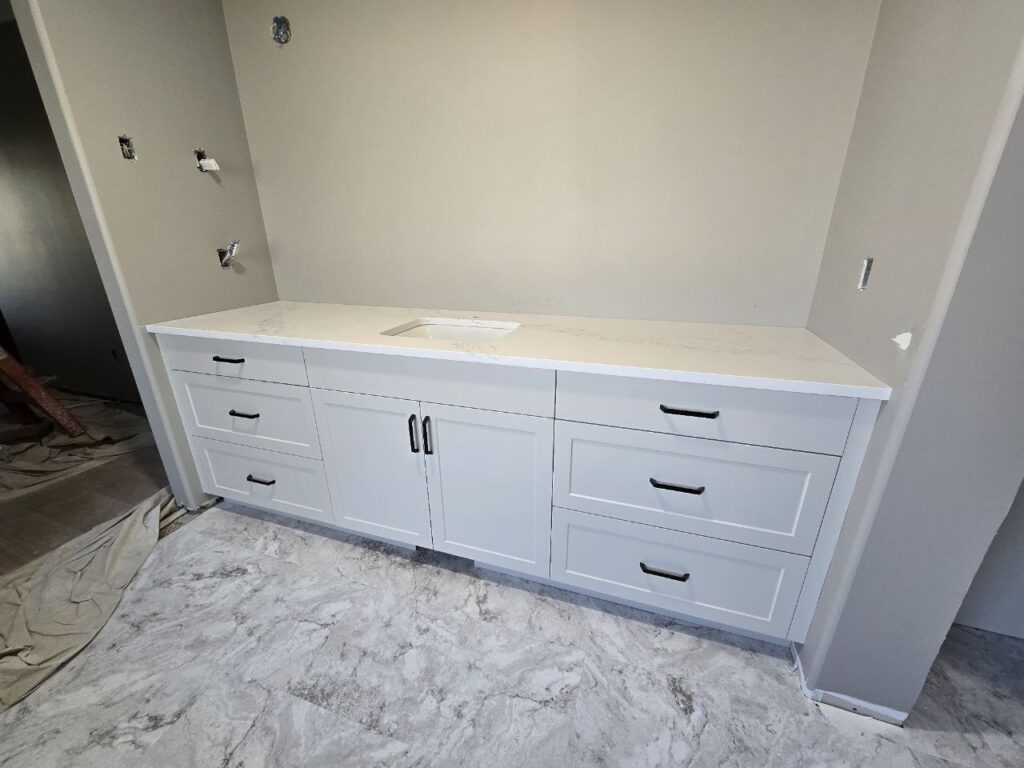 White cabinet with a white marble countertop