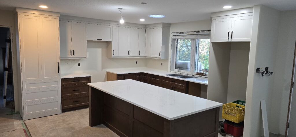 Kitchen with white cabinets and an island.
