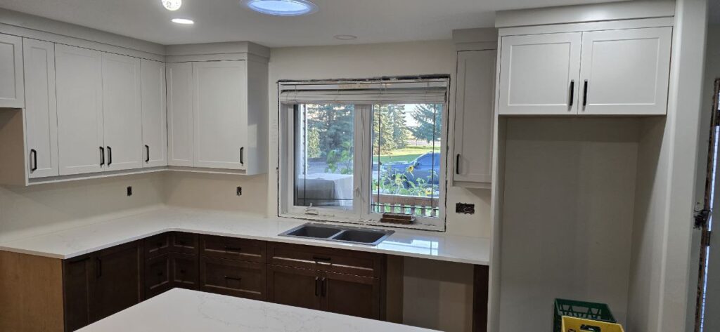 White wooden cabinets in a cozy kitchen.